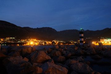 Fototapeta na wymiar Night landscape with the image of beacon near Bar port, Montenegro