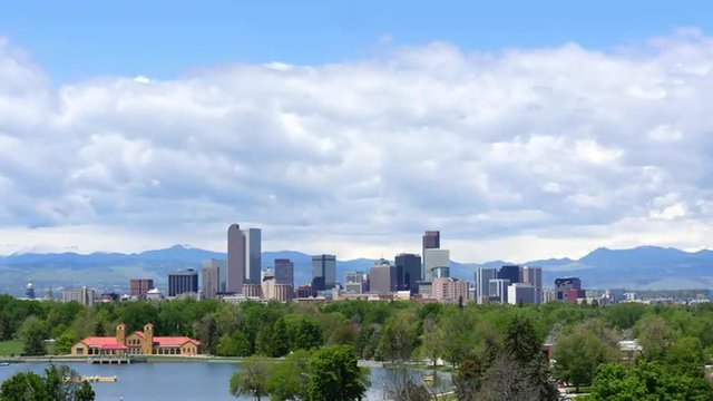 Fast, wide-angle time-lapse of downtown Denver Colorado, with City Park lake in the foreground. 4K UHD.