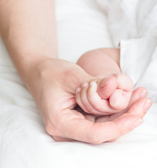 Mother's finger and baby hand