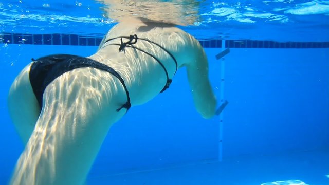 Woman swim in blue pool