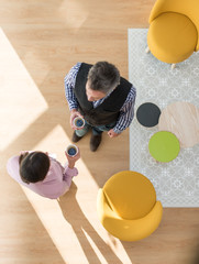 Top view of two co-workers having a break in a stylish vintage l