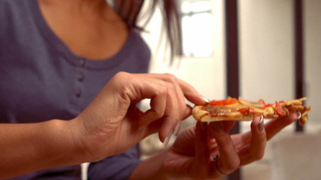 Smiling Hispanic Woman Eating Pizza