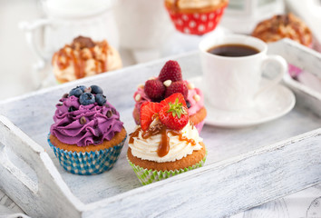 Different delicious cupcakes and coffee cup