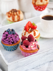 Different delicious cupcakes and coffee cup