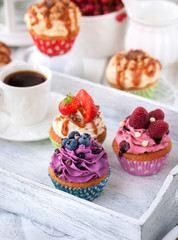 Different delicious cupcakes and coffee cup