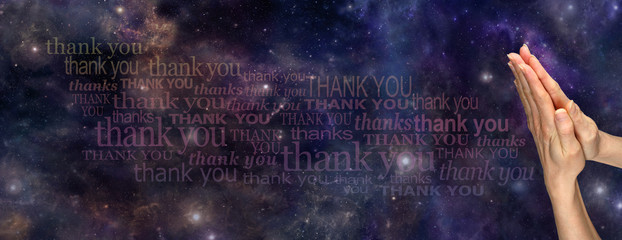 A Prayer of Thanks to the Universe     - Female hands in prayer position on a deep space background with the words 'Thank You' streaming across the page  - obrazy, fototapety, plakaty
