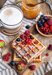 Belgian waffles with fresh berries and cappuccino