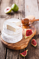 Brie cheese on a wooden Board with fresh Ingram and honey.selective focus.