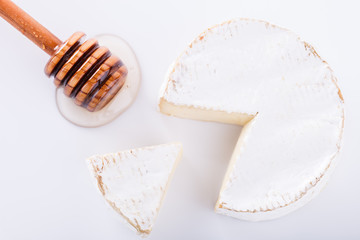 Brie cheese on with a white background with fresh Ingram and honey.selective focus.