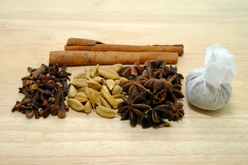 Various spices on a wooden background. 