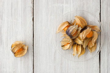 Ripe physalis on the white wooden table horizontal