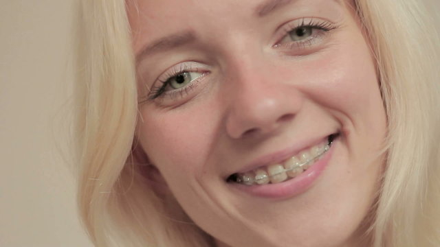 Smiling young girl with braces on teeth looking at camera 