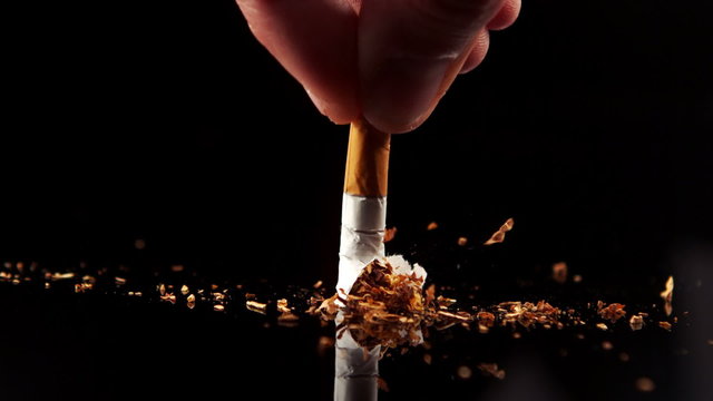 Hand squashing a cigarette