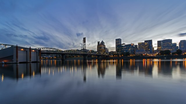 UHD 4k Timelapse Movie of Moving Clouds and Sunset into Blue Hour over City Skyline and Hawthorne Bridge in Downtown Portland Oregon along Willamette River 4096x2304
