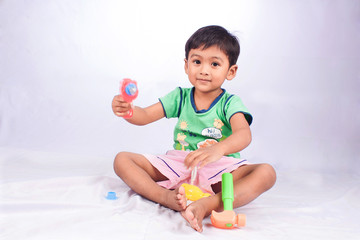 little asian boy play toy tool plastic on white background