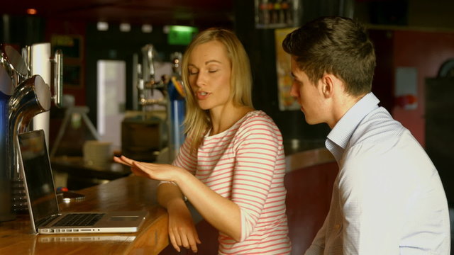 Colleagues working at the bar together