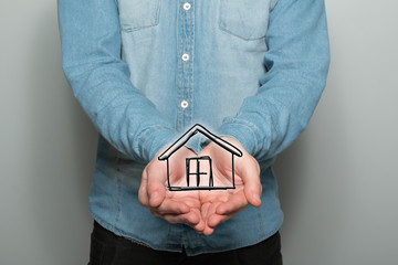 Man holds a house symbol