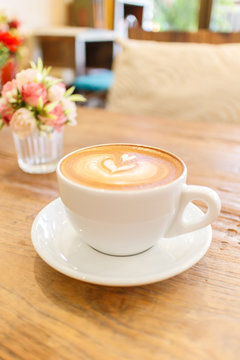 Cup of coffee latte art on wood table