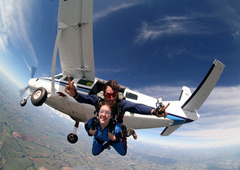 Sky diving tandem exit from the plane - 92994433