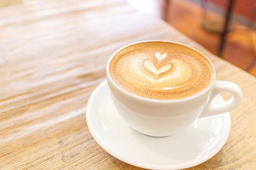 Cup of coffee latte art on wood table