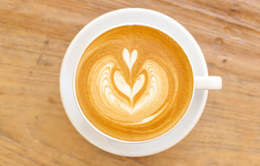Cup of coffee latte art on wood table