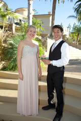Cute Teenage Prom Couple Outside The boy is giving his date a rose wrist corsage