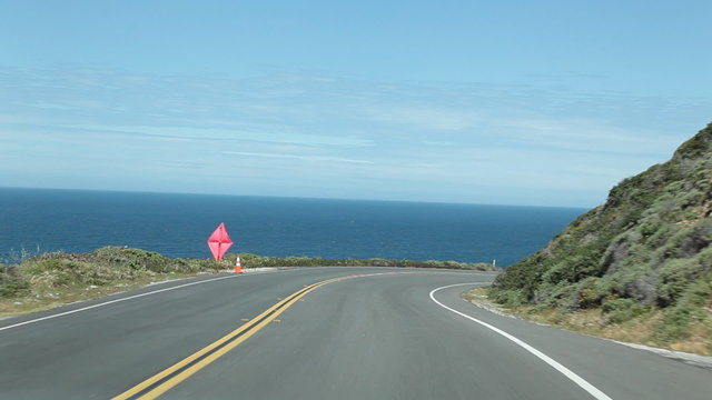 Vehicle point-of-view driving on Highway 1 (Pacific Coast Highway) in the Big Sur area of Central California.