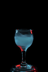 Aquamarine smoke in a glass. Halloween.
