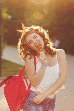 Pin-up girl licking a lollipop.