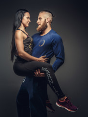 Man holding on arms woman.