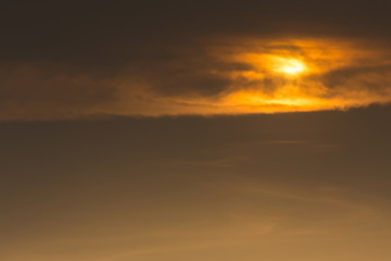 Fototapeta premium golden sky with clouds cover sun