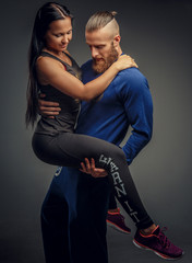 Man holding on arms woman.