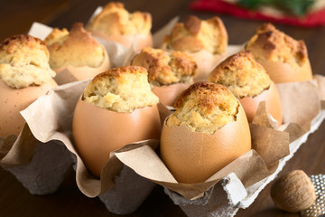 Eggnog cupcakes baked in eggshells, photographed with natural light (Selective Focus, Focus on the front of the first cupcake)