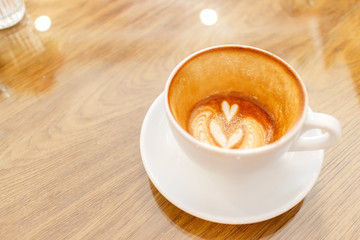 Cup of coffee latte art on wood table