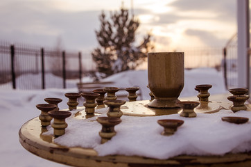 candle holder near orthodox church, at sunset time, russia