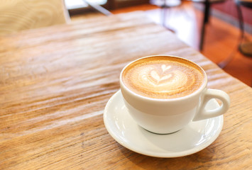 Cup of coffee latte art on wood table