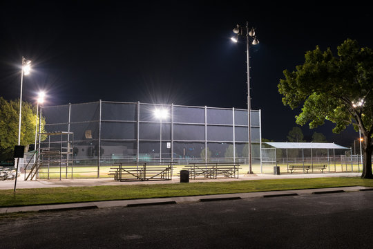 Empty baseball field with the lights on at night