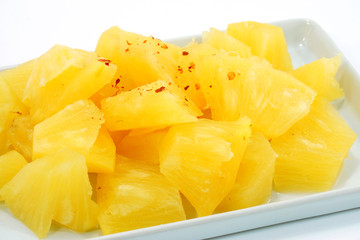 Pineapple slices in a white background.