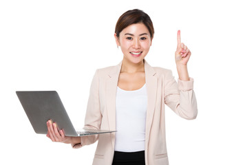 Young businesswoman use of the notebook computer and finger up