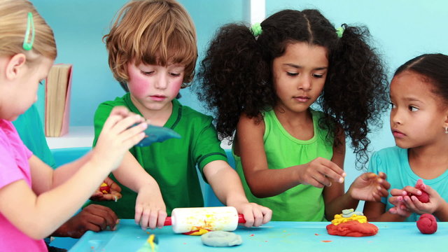 Little children using modelling clay