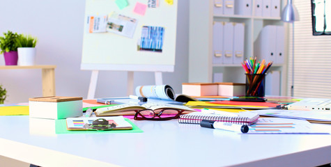 Office table with blank notepad and laptop 