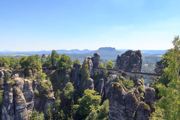Fototapeta na wymiar Panorama with Bastei Bridge, Neurathen Castle and table mountain Lilienstein in Rathen, Saxon Switzerland