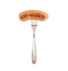 Grilled sausage in natural casing on a fork