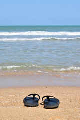 Pair of Flip Flops on sandy Beach