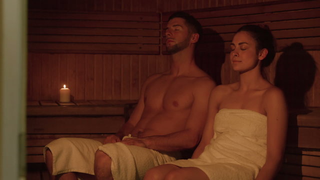 Couple relaxing in sauna together