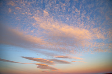 Naklejka na ściany i meble sunrise in the colored sky white soft clouds and abstract backgr