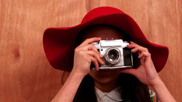 Hipster using a retro style camera