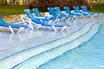 Empty beach chairs near  pool