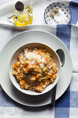 risotto with pumpkin on a blue tablecloth.olive oil and spices