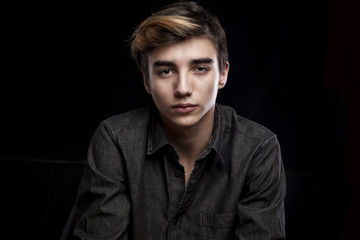 portrait of a young handsome man on black background